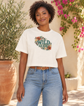 Wild As Her crop tee with a smaller floral graphic centered high on the chest
