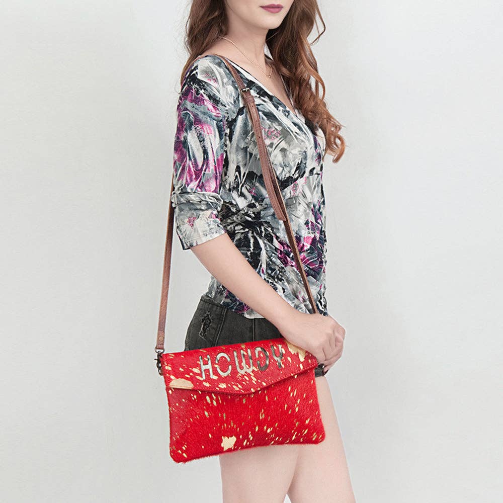 Ellie HOWDY red cowhide crossbody bag worn with its leather strap
