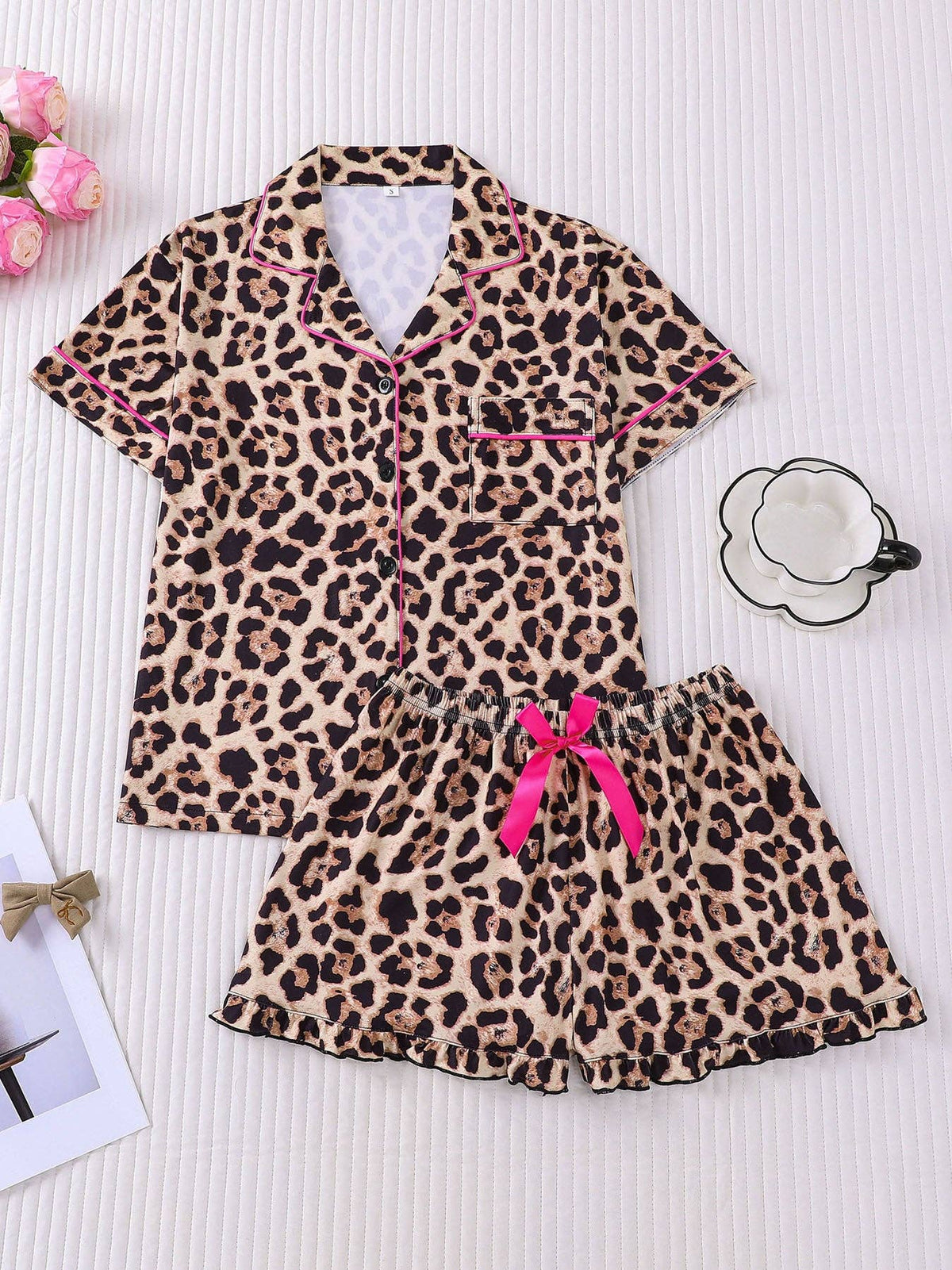 Leopard print pajama set with pink piping, pink bow, and ruffle-hem shorts
