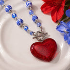 Red resin heart necklace with blue-and-white ceramic beads