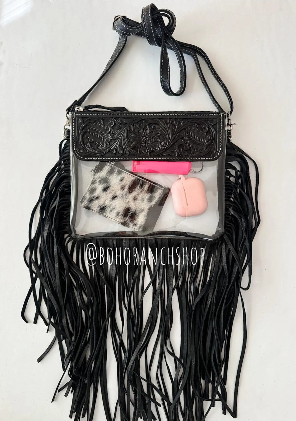 Black hand-tooled clear crossbody with fringe; contents not included